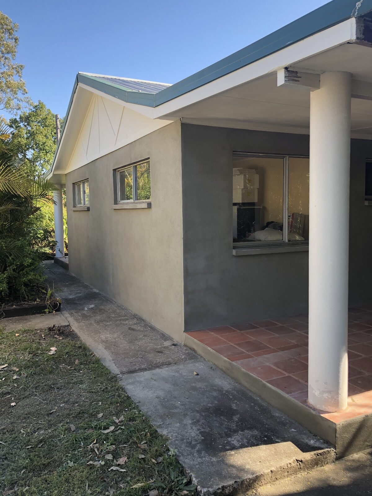 Same home — side elevation and entry — after render